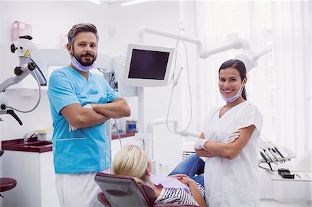 dentist with patient in exam room - Portrait of male and female dentist standing with arms crossed in dental clinic Stock Photo - Premium Royalty-Free, Code: 6109-08804002
