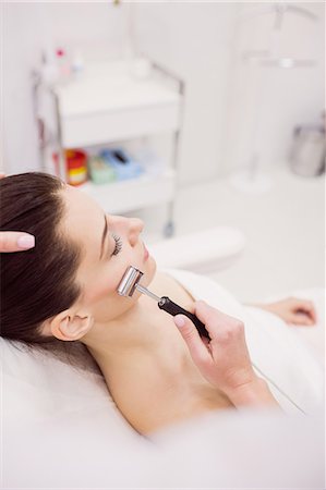simsearch:6109-08804015,k - Dermatologist performing laser hair removal on patient face in clinic Stock Photo - Premium Royalty-Free, Code: 6109-08804011