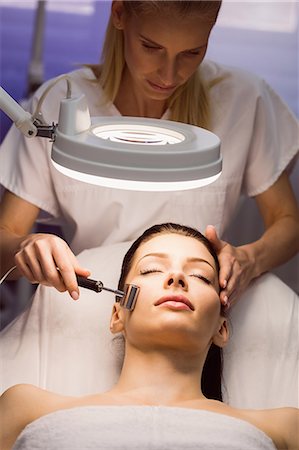simsearch:6109-08804015,k - Dermatologist performing laser hair removal on patient face in clinic Stock Photo - Premium Royalty-Free, Code: 6109-08804017