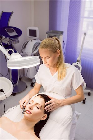 simsearch:6109-08804015,k - Dermatologist performing laser hair removal on patient face in clinic Stock Photo - Premium Royalty-Free, Code: 6109-08804014