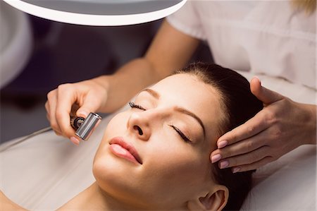 simsearch:6109-08804015,k - Dermatologist performing laser hair removal on patient face in clinic Stock Photo - Premium Royalty-Free, Code: 6109-08804018