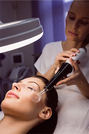 simsearch:6109-08804015,k - Dermatologist performing laser hair removal on patient face in clinic Stock Photo - Premium Royalty-Free, Code: 6109-08804025