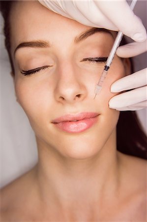 simsearch:6109-08804015,k - Female patient receiving an injection on her face in clinic Stock Photo - Premium Royalty-Free, Code: 6109-08804036