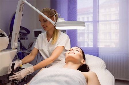 simsearch:6109-08804015,k - Dermatologist performing laser hair removal on patient face in clinic Stock Photo - Premium Royalty-Free, Code: 6109-08804039