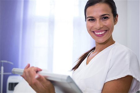 simsearch:6109-06005907,k - Portrait of smiling dentist using digital tablet in clinic Stock Photo - Premium Royalty-Free, Code: 6109-08804141