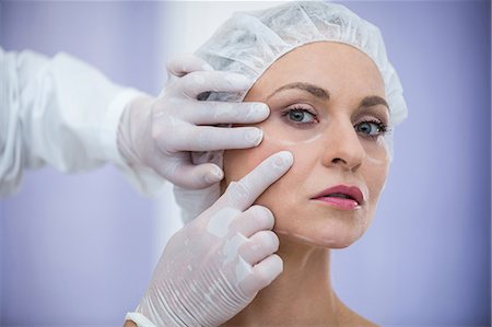 facial - Close-up of doctor examining female patients face for cosmetic treatment Stock Photo - Premium Royalty-Free, Code: 6109-08804173