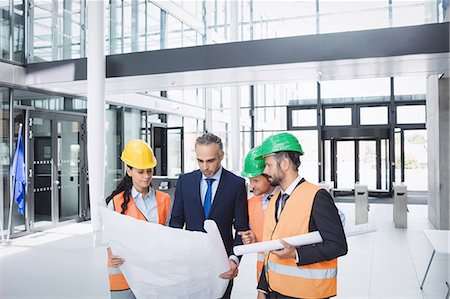 Businessman discussing on blueprint with architects in office building Stock Photo - Premium Royalty-Free, Code: 6109-08804262