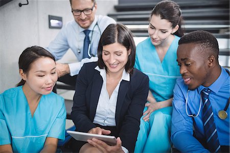 simsearch:6109-08804356,k - Doctors and nurse looking at digital tablet in hospital Stock Photo - Premium Royalty-Free, Code: 6109-08804355