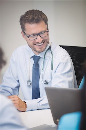 simsearch:6109-08804356,k - Smiling doctor in meeting at conference room Stock Photo - Premium Royalty-Free, Code: 6109-08804368