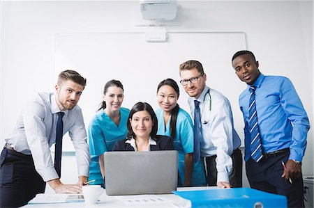simsearch:6109-08804356,k - Portrait of doctors smiling in conference room Stock Photo - Premium Royalty-Free, Code: 6109-08804377