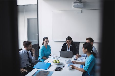 simsearch:6109-08804356,k - Team of doctors in a meeting at conference room Stock Photo - Premium Royalty-Free, Code: 6109-08804387