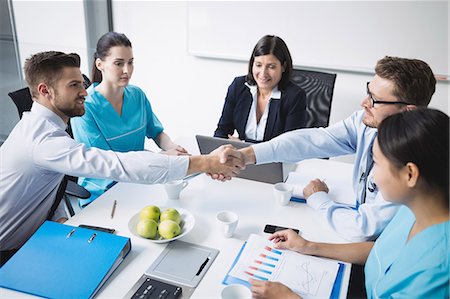 simsearch:6109-08804356,k - Doctors shaking hands with each other in meeting at conference room Stock Photo - Premium Royalty-Free, Code: 6109-08804385