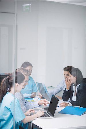simsearch:6109-08804356,k - Doctors discussing over laptop in meeting at conference room Stock Photo - Premium Royalty-Free, Code: 6109-08804391