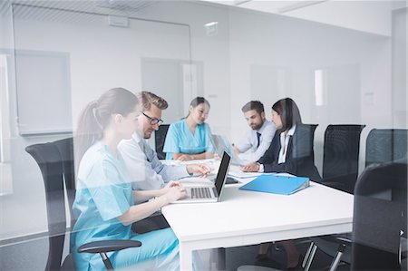 simsearch:6109-08804356,k - Doctors discussing over laptop in meeting at conference room Stock Photo - Premium Royalty-Free, Code: 6109-08804392