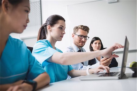 simsearch:6109-08804356,k - Doctors discussing over laptop in meeting at conference room Stock Photo - Premium Royalty-Free, Code: 6109-08804397