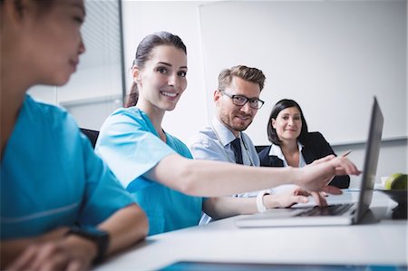 simsearch:6109-08804356,k - Doctors discussing over laptop in meeting at conference room Stock Photo - Premium Royalty-Free, Code: 6109-08804398
