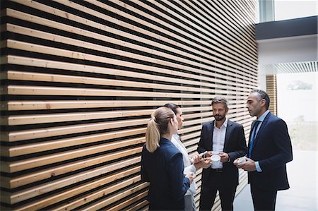 Businesspeople having tea and interacting during breaktime in office Stock Photo - Premium Royalty-Free, Code: 6109-08804468