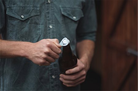 pictures man opening bottle - Close-up of man opening a beer bottle Stock Photo - Premium Royalty-Free, Code: 6109-08804539