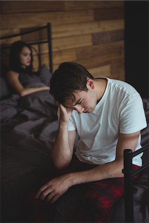 simsearch:6109-07601529,k - Upset couple ignoring each other after fight on bed in bedroom Stock Photo - Premium Royalty-Free, Code: 6109-08804836