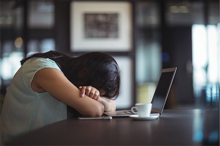 simsearch:6109-08700458,k - Upset businesswoman sitting at her desk in office Stock Photo - Premium Royalty-Free, Code: 6109-08805159