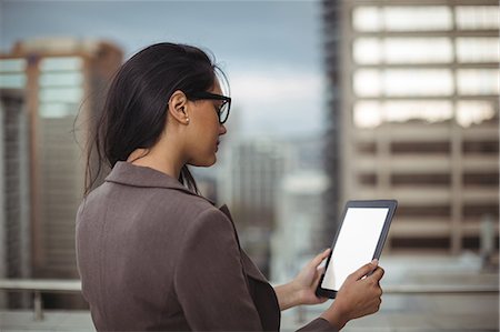 Businesswoman using digital tablet on office terrace Stock Photo - Premium Royalty-Free, Code: 6109-08805119