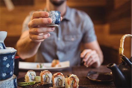 sake - Mid-section of man showing cup Stock Photo - Premium Royalty-Free, Code: 6109-08829511