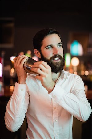 Bartender shaking the shaker at the bar Stock Photo - Premium Royalty-Free, Code: 6109-08829848