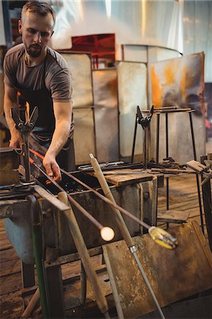 Glassblower shaping a molten glass Stock Photo - Premium Royalty-Free, Code: 6109-08830205