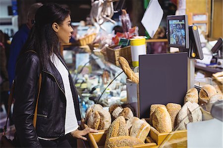 simsearch:400-06529822,k - Woman standing at bread counter Photographie de stock - Premium Libres de Droits, Code: 6109-08830354