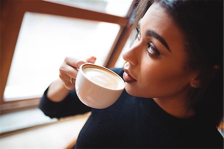simsearch:6113-07790833,k - Beautiful woman having a cup of coffee in cafée Stock Photo - Premium Royalty-Free, Code: 6109-08830379