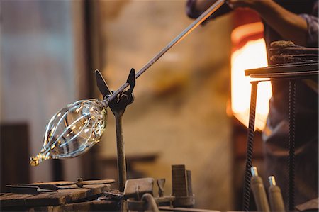 Glassblower shaping a molten glass Foto de stock - Sin royalties Premium, Código: 6109-08830323