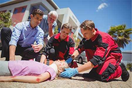 emergency services - Paramedics examining injured girl Stock Photo - Premium Royalty-Free, Code: 6109-08830415
