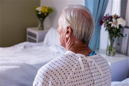 simsearch:6113-06908281,k - Thoughtful male senior patient sitting in the ward Stock Photo - Premium Royalty-Free, Code: 6109-08830546