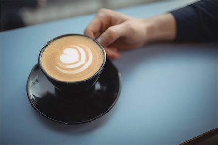 Hand of male executive holding coffee cup in cafeteria Stock Photo - Premium Royalty-Free, Code: 6109-08944252