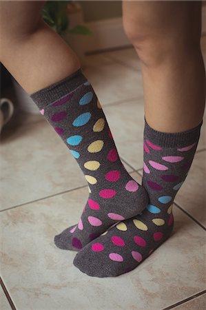 simsearch:6109-07497438,k - Womans feet wearing multicolored polka dots socks at home Stock Photo - Premium Royalty-Free, Code: 6109-08944374