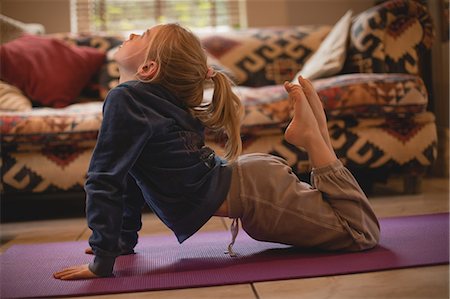 simsearch:400-06872329,k - Girl performing yoga in living room at home Stock Photo - Premium Royalty-Free, Code: 6109-08944550