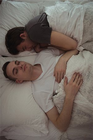 High angle view of gay couple sleeping together on the bed Stock Photo - Premium Royalty-Free, Code: 6109-08944645