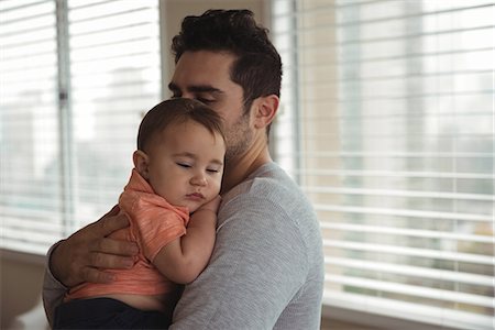 simsearch:6113-07543205,k - Father comforting his baby at home Stock Photo - Premium Royalty-Free, Code: 6109-08944697