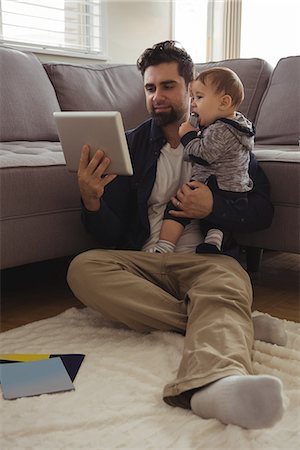 simsearch:6116-07236010,k - Father holding his baby while using digital tablet at home Stock Photo - Premium Royalty-Free, Code: 6109-08944730