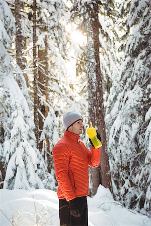 simsearch:6113-07790833,k - Man drinking water from bottle in forest during winter Stock Photo - Premium Royalty-Free, Code: 6109-08944867
