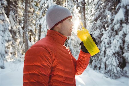 simsearch:6113-07790833,k - Man drinking water from bottle in forest during winter Stock Photo - Premium Royalty-Free, Code: 6109-08944868