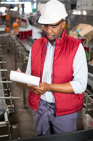 record (file of information) - Confident male employee noting about products in juice factory Stock Photo - Premium Royalty-Free, Code: 6109-08945149