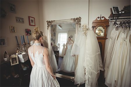 simsearch:700-03696805,k - Young bride in a white dress looking into mirror in a boutique Stock Photo - Premium Royalty-Free, Code: 6109-08945253