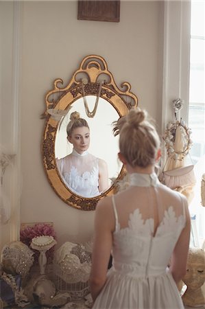 simsearch:700-03696805,k - Young bride in a white dress looking into mirror in a boutique Stock Photo - Premium Royalty-Free, Code: 6109-08945255
