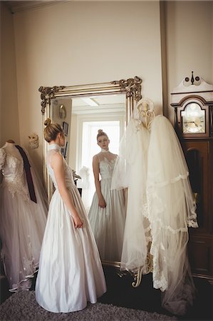simsearch:700-03696805,k - Young bride in a white dress looking into mirror in a boutique Stock Photo - Premium Royalty-Free, Code: 6109-08945258