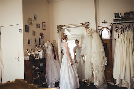simsearch:700-03696805,k - Young bride in a white dress looking into mirror in a boutique Stock Photo - Premium Royalty-Free, Code: 6109-08945259