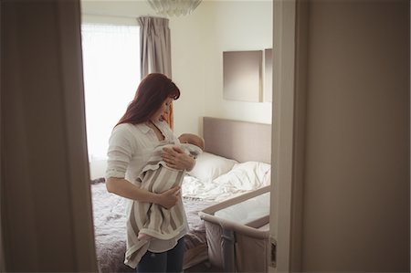 simsearch:6102-08566788,k - Mother breast feeding baby in bedroom Stock Photo - Premium Royalty-Free, Code: 6109-08945212