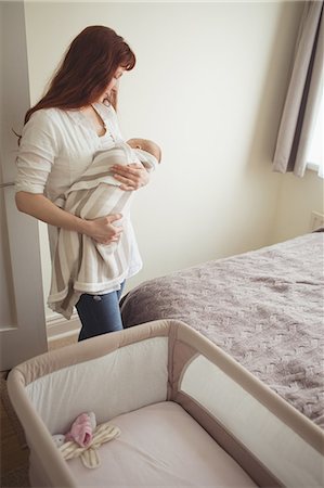 simsearch:6102-08566788,k - Mother breast feeding baby in bedroom at home Stock Photo - Premium Royalty-Free, Code: 6109-08945214