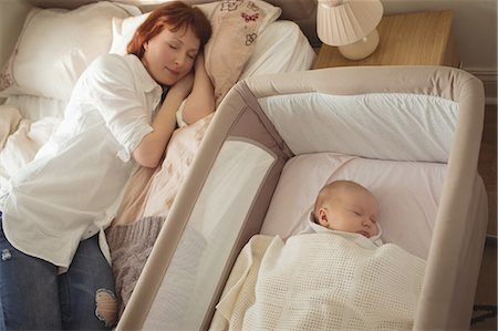 simsearch:6102-08566788,k - High angle view of mother and baby sleeping in bedroom Stock Photo - Premium Royalty-Free, Code: 6109-08945221