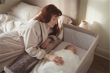 simsearch:6102-08566788,k - High angle view of mother watching sleeping baby in crib Stock Photo - Premium Royalty-Free, Code: 6109-08945225
